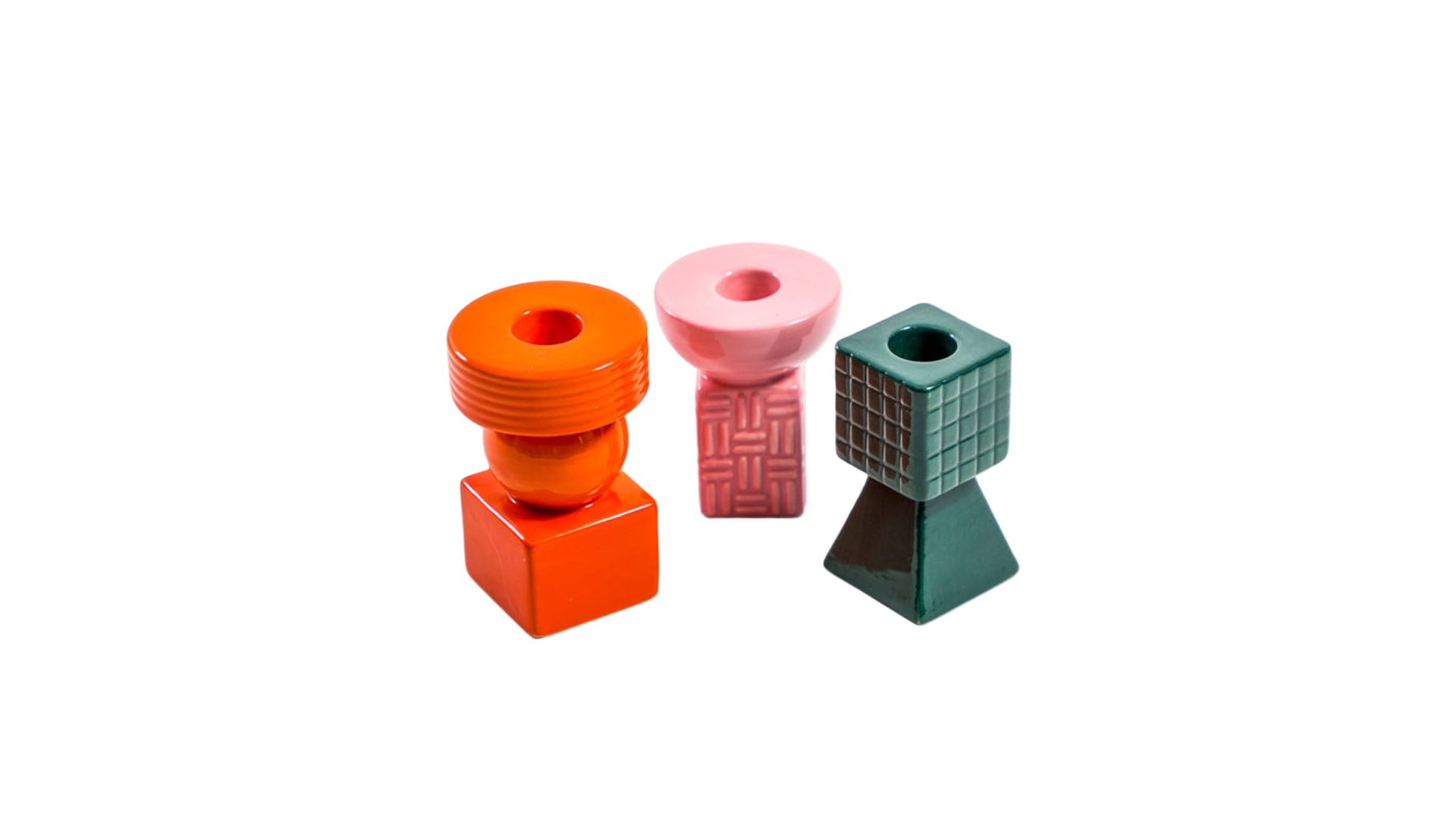Three colorful geometric candlestick holders on a white background