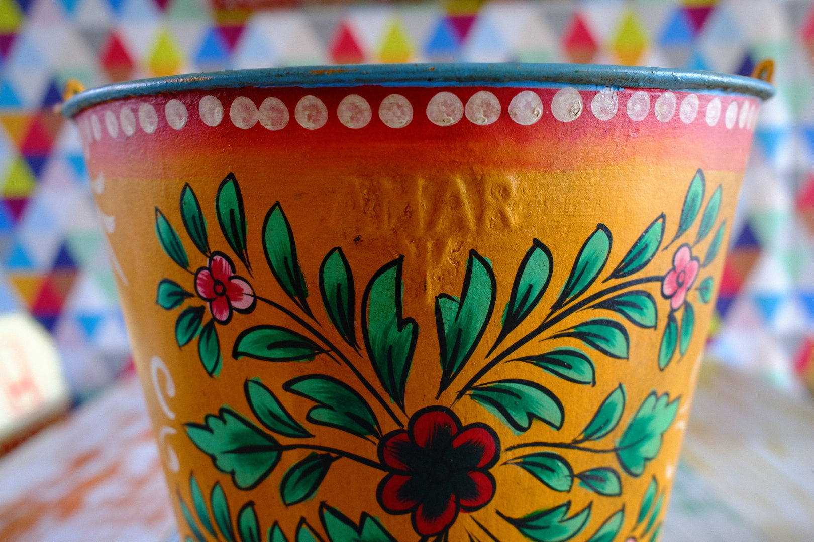 Decorative vintage style hand painted bucket  with floral patterns on a colorful background