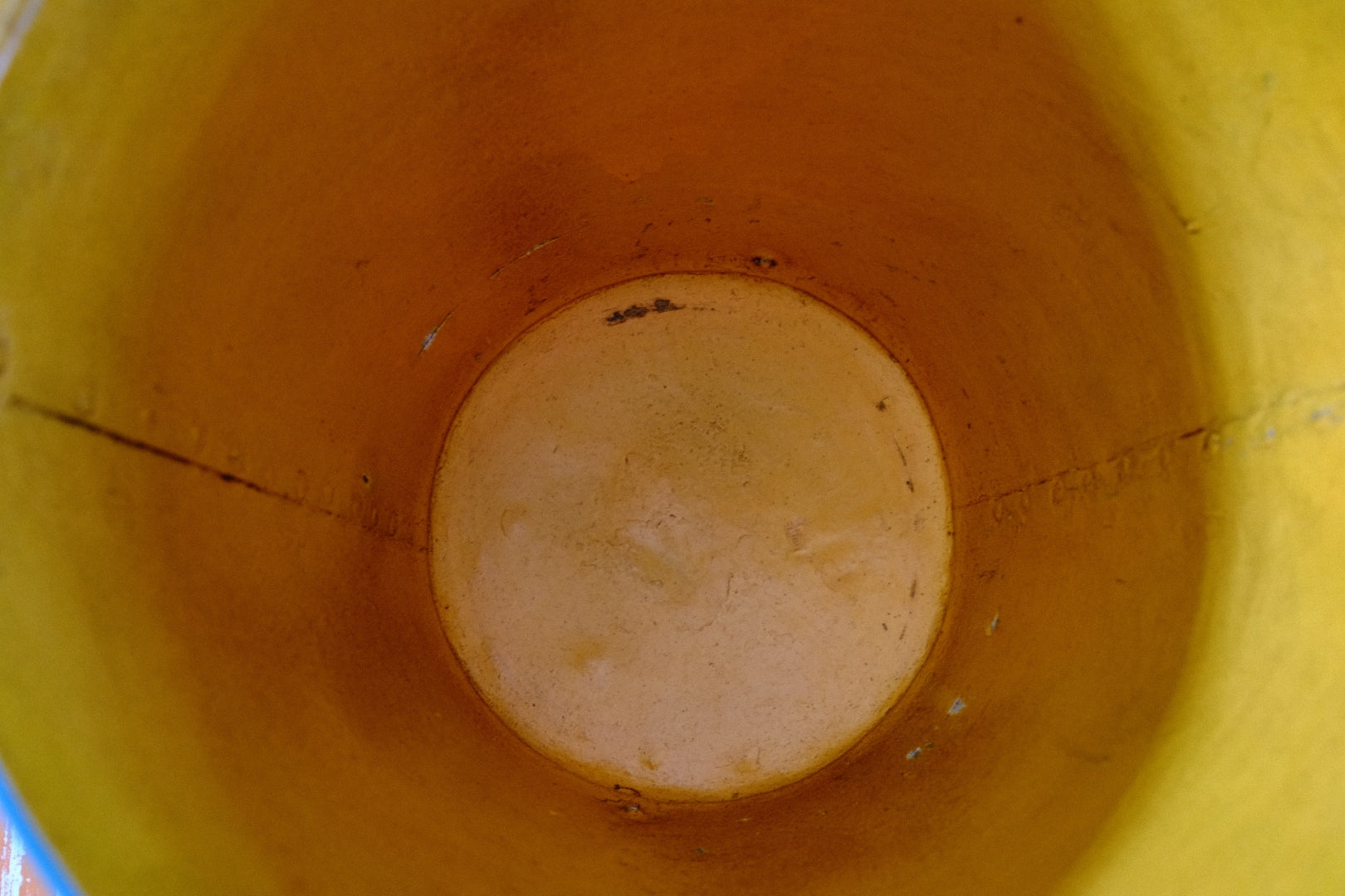 Close-up of a yellow bucket's interior with a circular white patch.