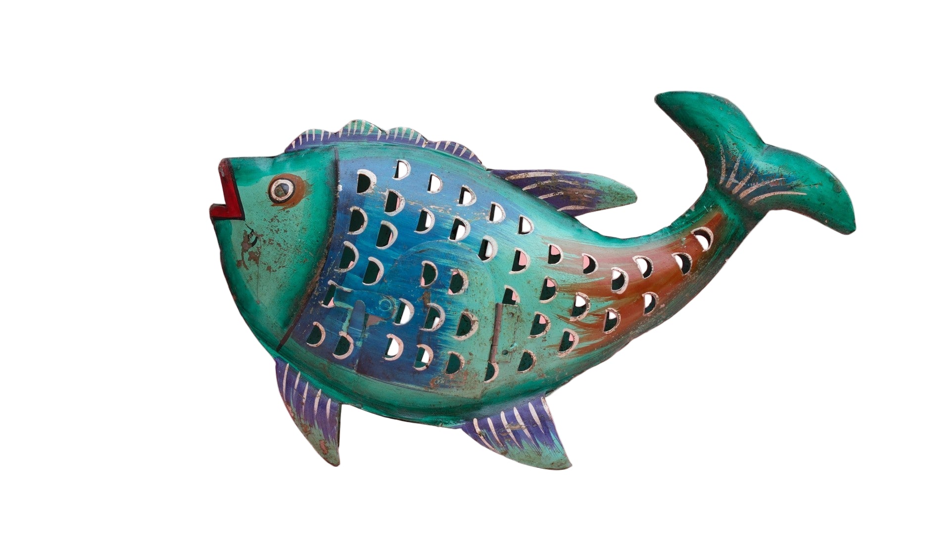 Decorative fish-shaped object with cut-out patterns on a pink background