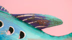 Decorative fish-shaped birdhouse with a pink background