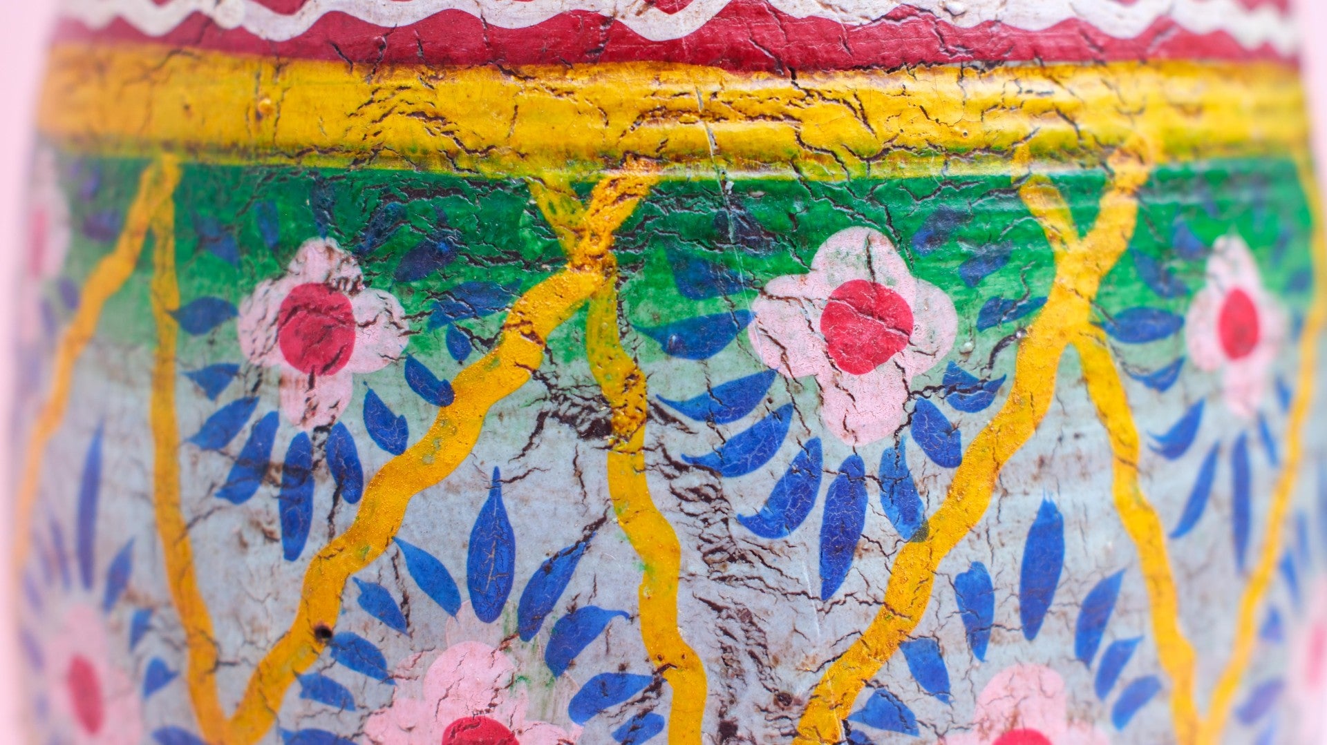 Decorative object with floral patterns and cracked paint