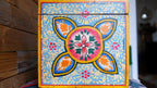 Decorative box with colorful floral design on a wooden surface