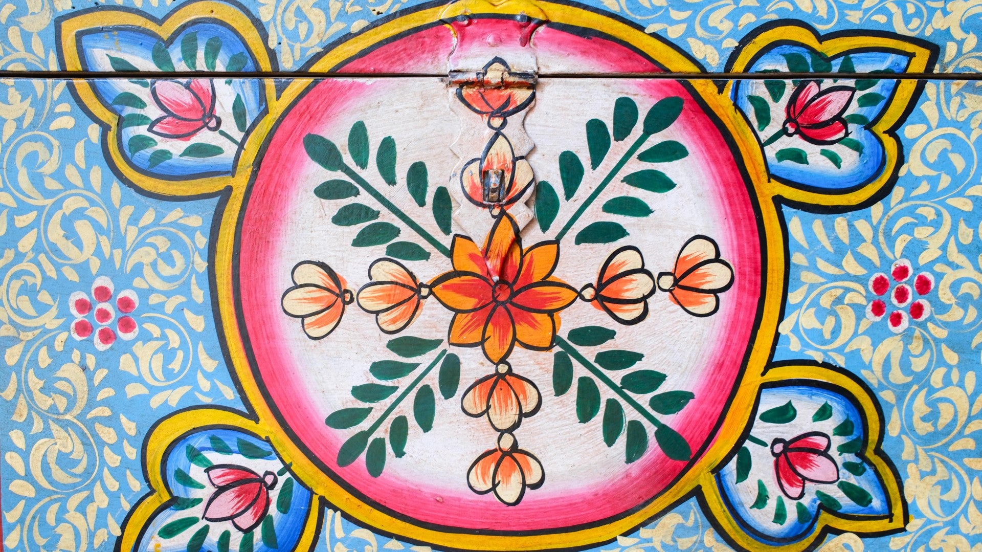 Decorative tile with floral design on a blue background