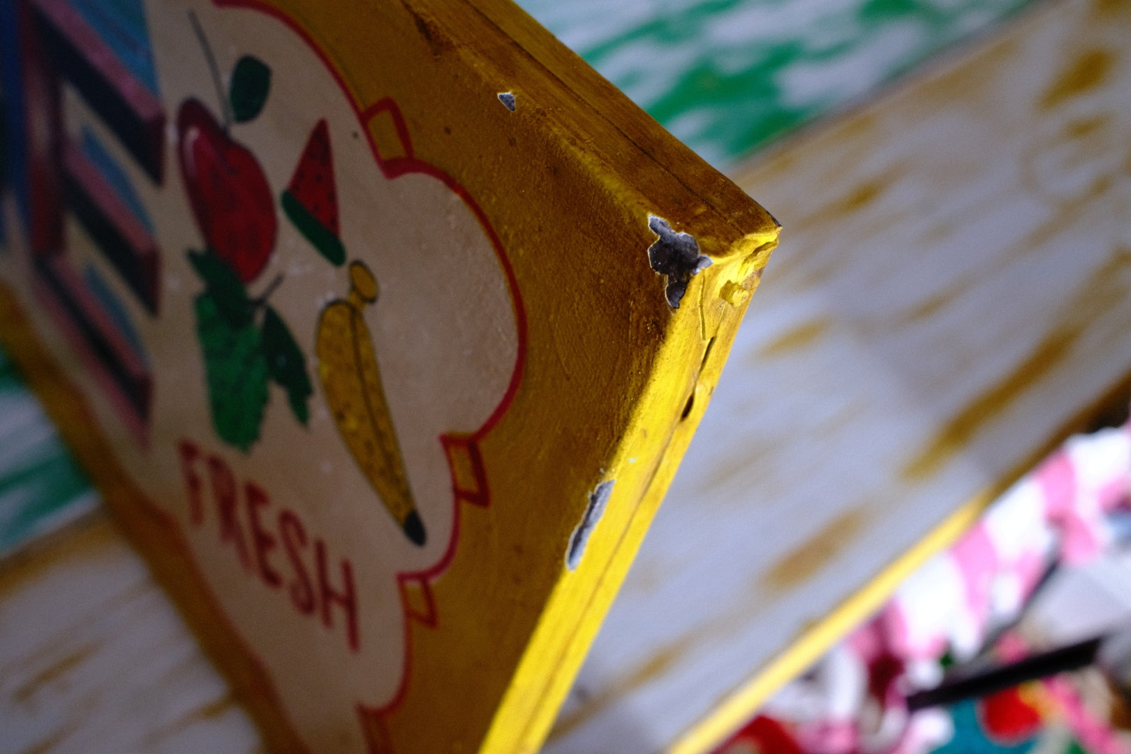 Close-up of a yellow box with 'Fresh' text and graphics on a colorful background