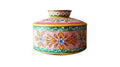 Colorful metal container with floral patterns on a wooden surface