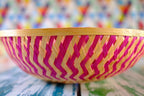 Pink zig-zag patterned bamboo basket handwoven with natural fibres