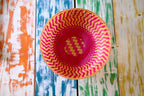 Pink zig-zag patterned bamboo basket handwoven with natural fibres