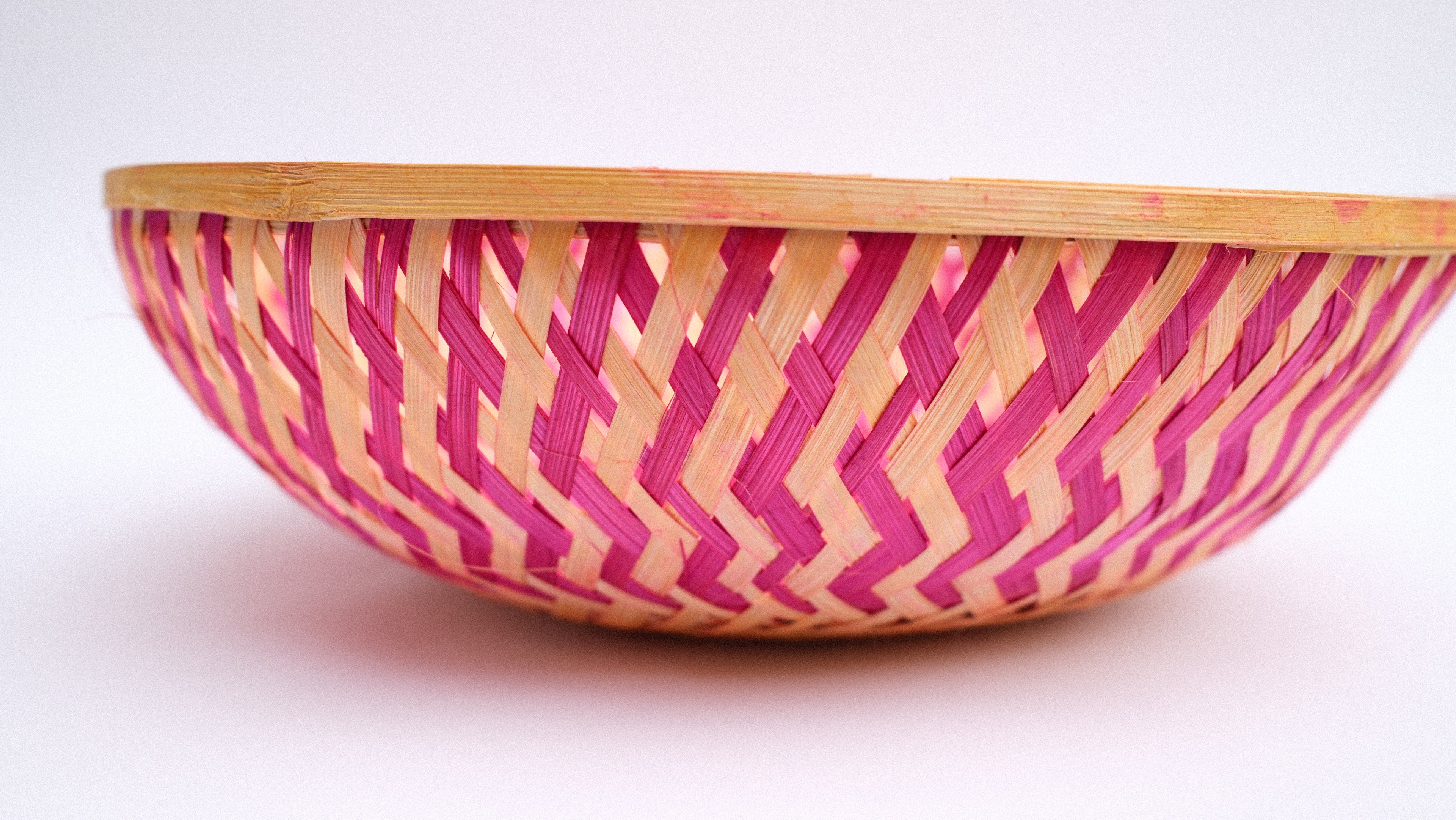 Pink zig-zag patterned bamboo basket handwoven with natural fibres