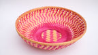 Pink zig-zag patterned bamboo basket handwoven with natural fibres