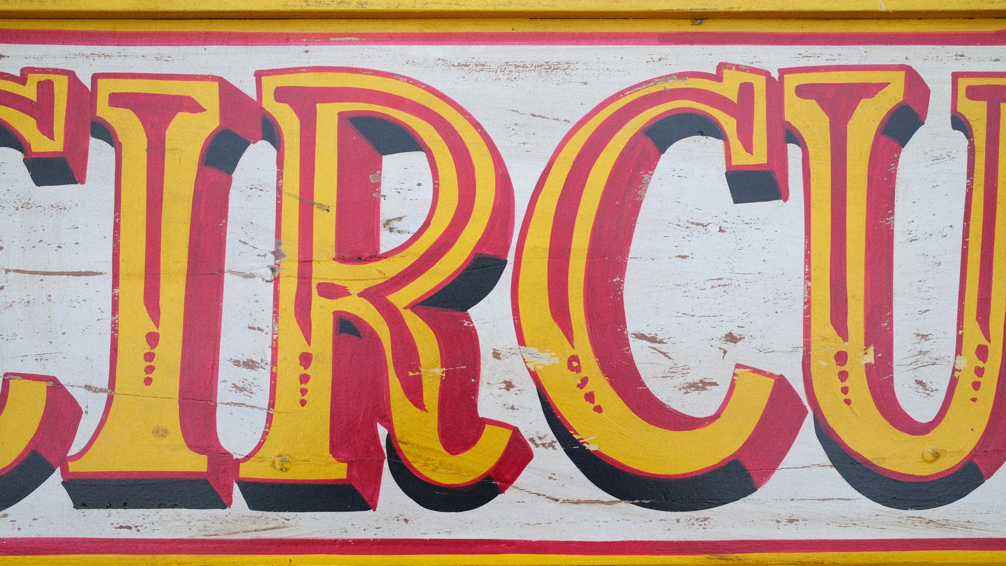 Vintage-style sign with 'CIRCUS' text on a wooden background