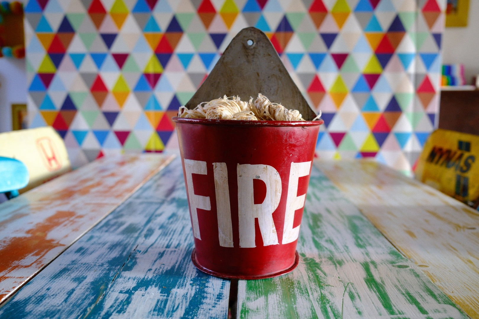 Vintage style red fire wall bucket with firelighters inside. Firelighter storage