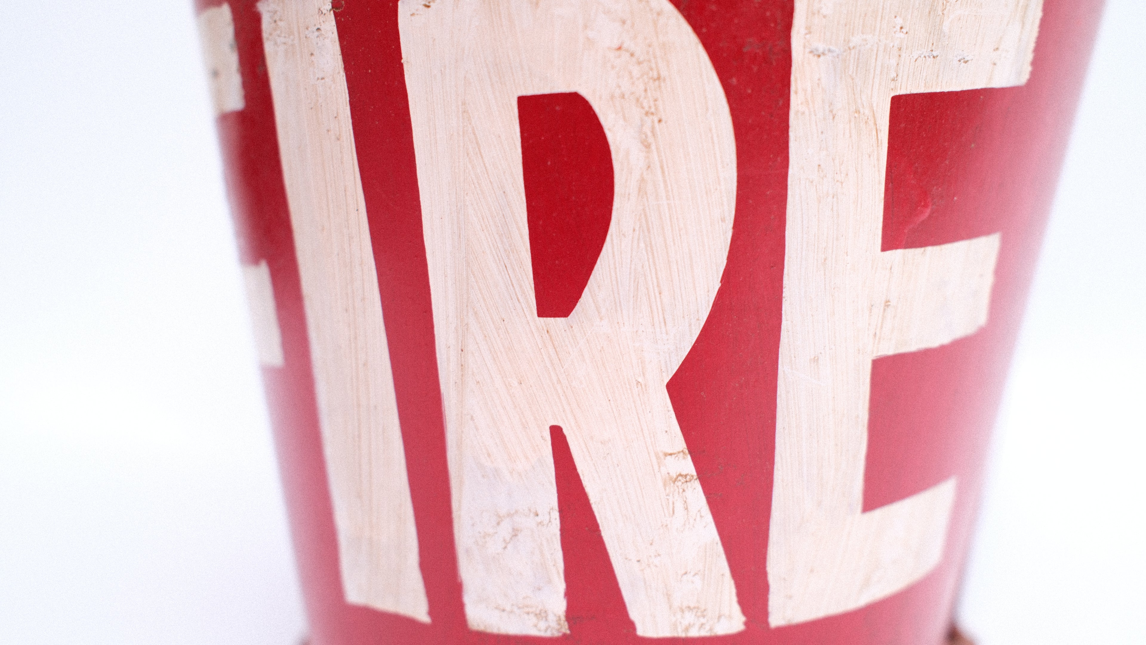 Red fire bucket with 'FIRE' text on a white background
