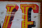 Vintage-style letter with red and yellow colors on a textured background