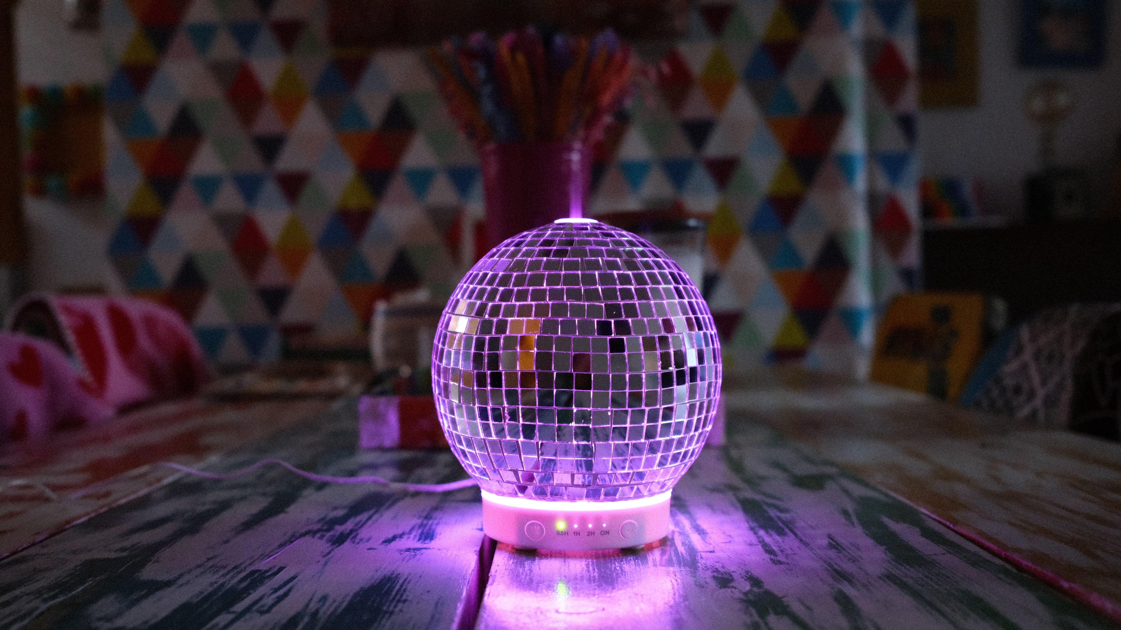  disco ball diffuser on a table with colorful background