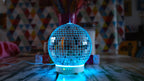 Discoball diffuser on a table with a colorful geometric patterned wall in the background