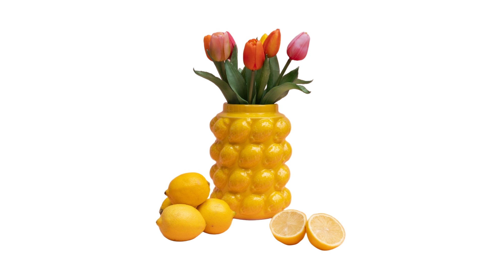 Lemon shaped vase with tulips and lemons on a white background