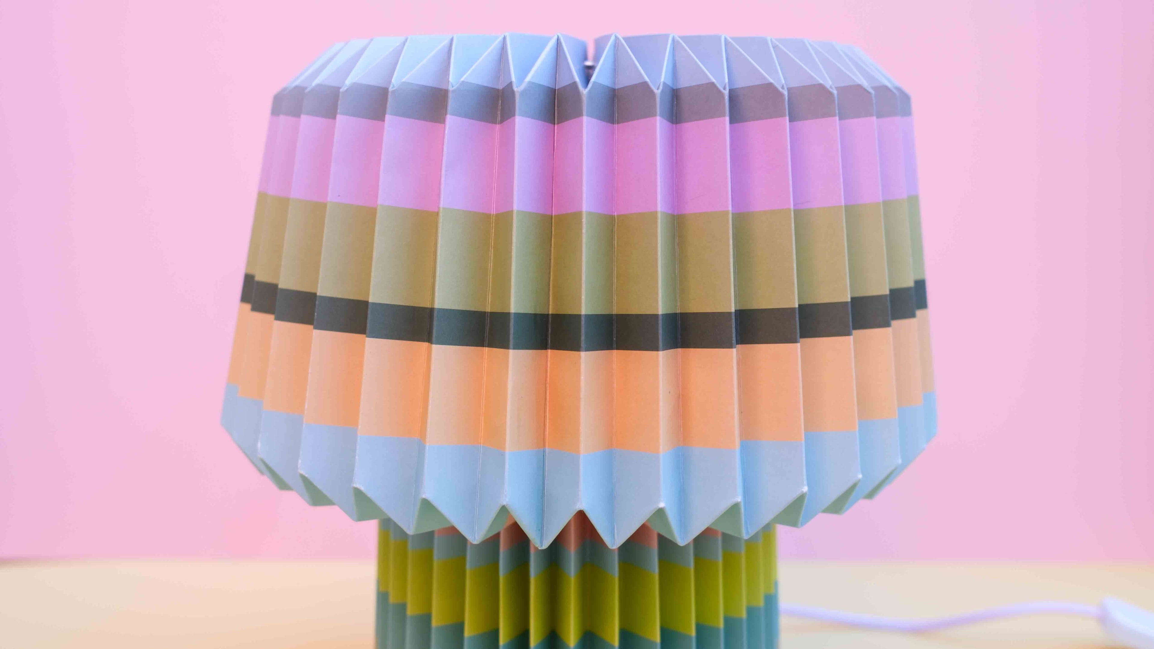 Colorful lamp with a plaid pattern on a pink background