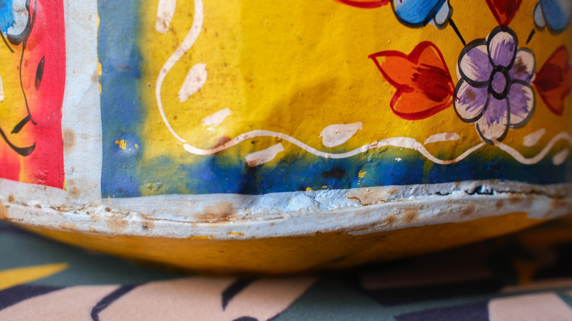 Close-up of a colourful container with floral patterns